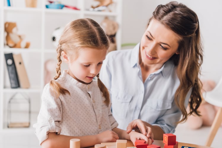 Woman and girl playing with blocks