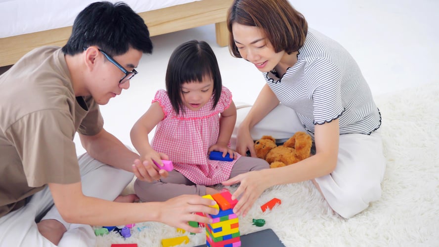 Parents playing with blocks with their child with special needs