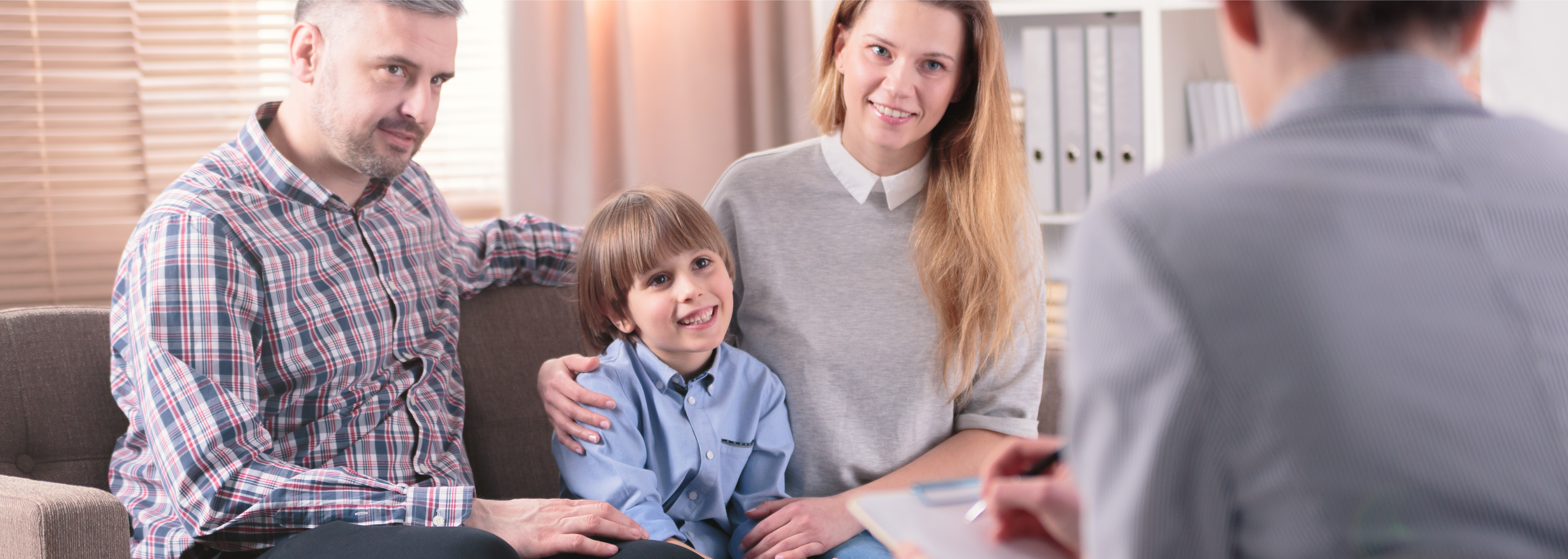 Young boy and his parents speaking with a mental health professional